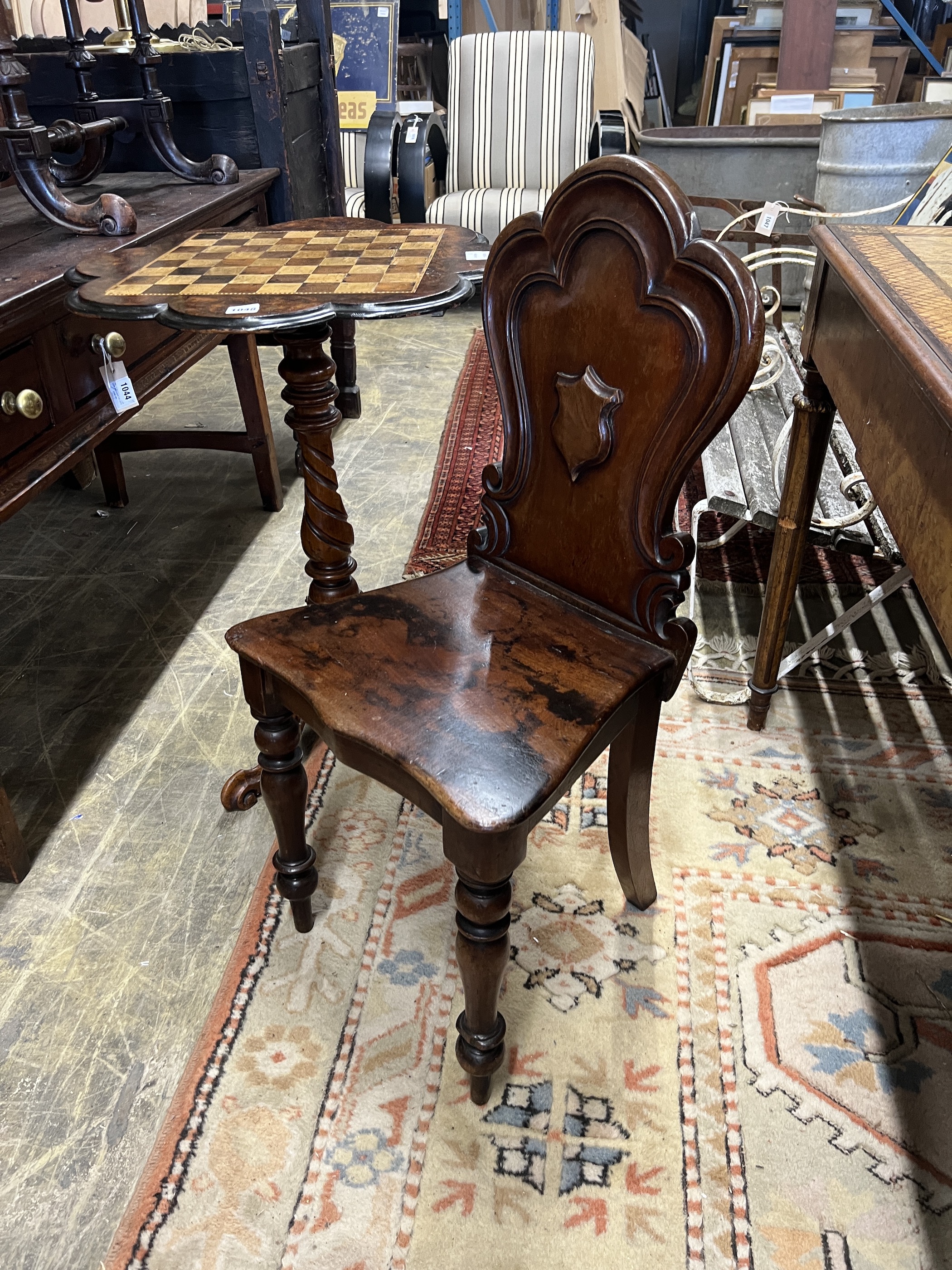 A Victorian mahogany hall chair and a Victorian walnut tripod games table, width 56cm, height 73cm